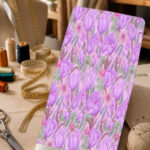 Soft lavender tulip floral print with pink blossoms and fresh green accents on a pale pink background.