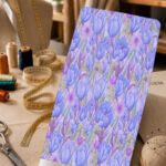 Soft blue tulip floral print with lavender blossoms and delicate green accents on a pale lilac background.
