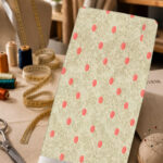 Coral polka dots on a soft textured beige background.