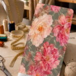 Large painterly pink and blush flowers on a muted gray-green background.