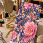 Elegant pink floral print with golden-beige leaves on a rich navy blue background.