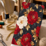 Elegant red and ivory flowers with golden leaves on a deep black background.