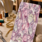 Soft pink, ivory, and silver botanical motifs on a muted lavender background.