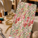 Vintage red and pink florals with olive-green leaves on a soft ivory background.