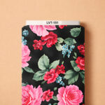 Striking floral design featuring vibrant pink and red blossoms, soft blue accents, and lush green leaves against a deep black background.