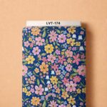 Playful pastel florals in pink, yellow, and blue over a rich royal-blue background.