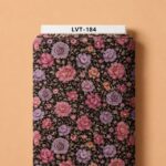 Rich pink and lavender blooms with delicate foliage over a deep black background.