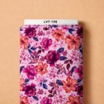 Bold magenta and orange florals with deep blue leaves on a soft pink background.