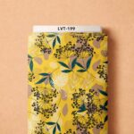 Artistic black florals and teal leaves over a vibrant mustard-yellow abstract background.
