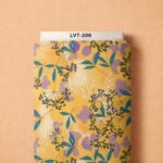 Delicate black botanicals and teal leaves with soft lilac accents on a warm golden background.