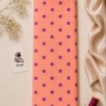 Premium printed silk fabric featuring playful purple polka dots on a soft peach background-Italian Silk (ST01)