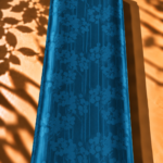 Captivating blossoms flow across sleek vertical lines in a deep teal blue tone - Jacquard Silk (JD08x2)