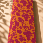 Vibrant orange Spanish cotton with bold magenta floral vines and elegant rose motifs - Spanish Cotton (PC11)