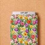 Vibrant tulip garden in purple, pink, yellow, orange, and blue tones with lush green foliage on a fresh white background.