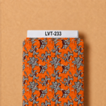 Bold spotted lily floral print in black and white over a vibrant orange background.