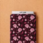 Elegant pink floral print with deep burgundy leaves and delicate winding vines on a rich dark background.