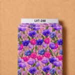 Vibrant purple, violet, blue, and fuchsia tulip floral print with fresh green leaves on a soft blush pink background.
