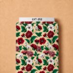 Rich red and white floral print with vibrant emerald green leaves on a warm cream background.