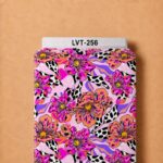 Vibrant artistic floral print with bold pink and orange blooms, purple accents, and playful black-and-white spotted leaves.