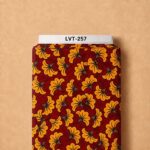 Bold floral print with golden-orange blooms layered over a rich deep-red botanical background.
