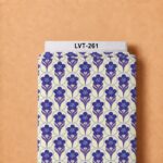 Retro floral print with stylized purple blooms and blue accents arranged in a clean geometric repeat on a soft cream background.