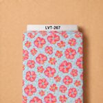Playful floral pattern with vibrant coral and pink blooms on a soft aqua blue background, accented with colorful dots.