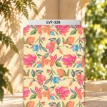 Bright watercolor floral print with pink, orange, and blue blooms accented by soft green leaves on a warm cream background