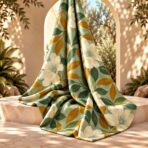⁦Elegant ivory floral print with deep green and warm amber leaves on a soft sage background.⁩ - الصورة ⁦2⁩