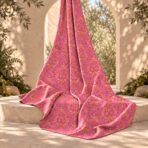 ⁦Ornamental pink motifs arranged over a vibrant orange background.⁩ - الصورة ⁦2⁩