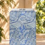 Intricate abstract motifs in layered shades of blue, grey, and ivory.