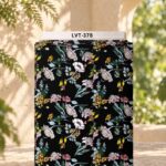 Delicate multicolor wildflowers with soft green and blue leaves on a deep black background.