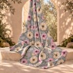 ⁦Soft pink and ivory floral design on a dusty blue background with delicate botanical leaves.⁩ - الصورة ⁦2⁩