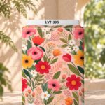 Vibrant colorful flowers and green leaves on a soft peach-pink background.