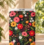 Vibrant red, pink and yellow flowers with green leaves on a deep black background.