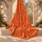 Bold gold chain pattern with subtle leopard accents on a vibrant orange-red background. - Image 2