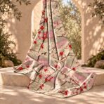 ⁦Elegant red and ivory blossoms on soft beige and pink tones.⁩ - الصورة ⁦2⁩
